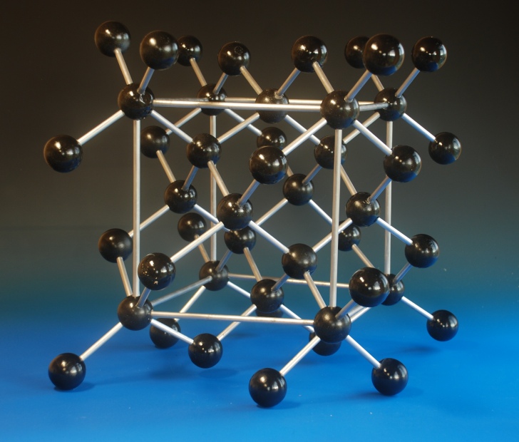 A large crystal structure model of Diamond, showing the unit cell, made with large wooden balls and aluminium rods